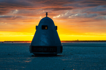 Garbage disposal unit on the "IJmuiden aan zee" beach in the sunset