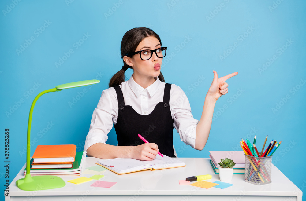 Canvas Prints photo of amazed high school girl sit table write copybook point index finger copyspace make lips pou