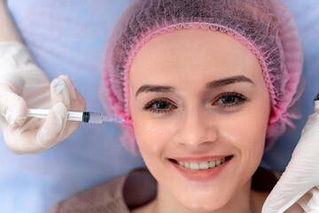 Cosmetic medicine. Injection near eyes. Botox in syringe. Beauty concept. Portrait of a client.