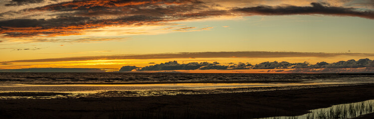 Panorama of the Baltic Sea coast, sand and sun, sunset