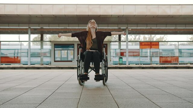 Happy young independent disabled woman on the train station. High quality 4k footage