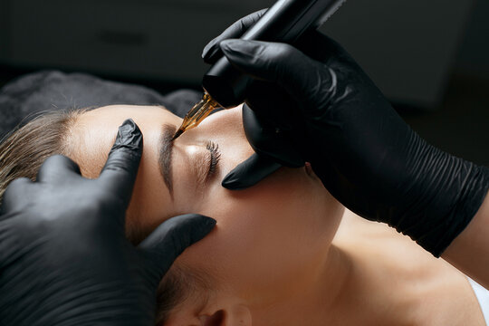 Closeup  shot of a woman applying permanent makeup