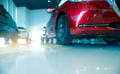 Blurred red and white car parked in modern showroom. Car dealership and auto leasing concept....