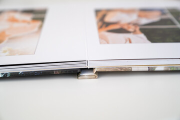 close up. photo book binding. storing photos from a photo session in a photobook. the result of the...