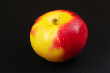 Red-sided apple on a black background
