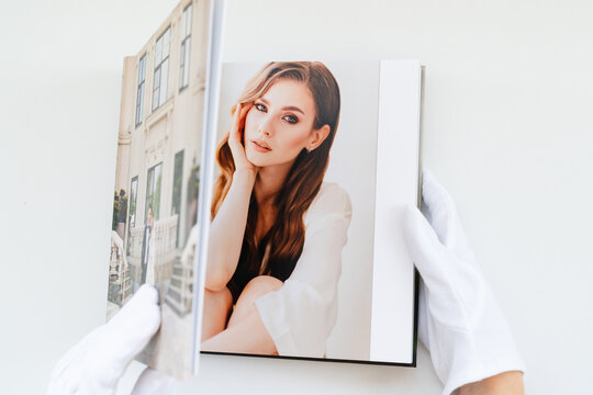 hands in white gloves flipping through a photo book with wedding photos. beautiful and convenient storage of the memory of an important day.