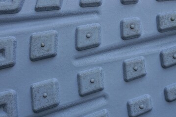 gray background of a piece of plastic sole with a pattern