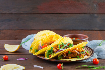 Mexican tacos with corn tortilla and meat on wooden background