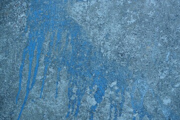 Fototapeta na wymiar gray dirty concrete wall with a big blue stain of paint
