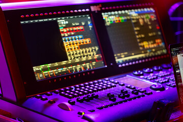 Audio sound mixer console with buttons, sliders and displays at the concert