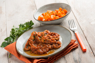 baby octopus with tomato sauce and pumpkin salad