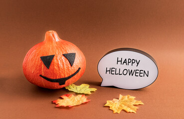 Decorative pumpkin, autumn leaves and a white ad frame with a welcome message on. The concept of...