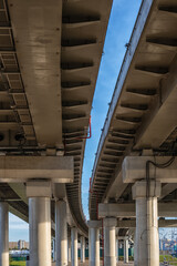 Under a double modern automobile overpass on columns