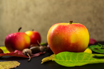 Apples on autumn leaves, on a black background