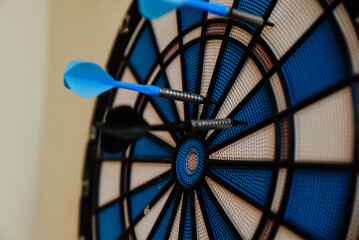 dart in the center. target with darts in blue color