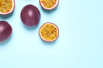 Fresh ripe passion fruits (maracuyas) on light background, flat lay. Space for text