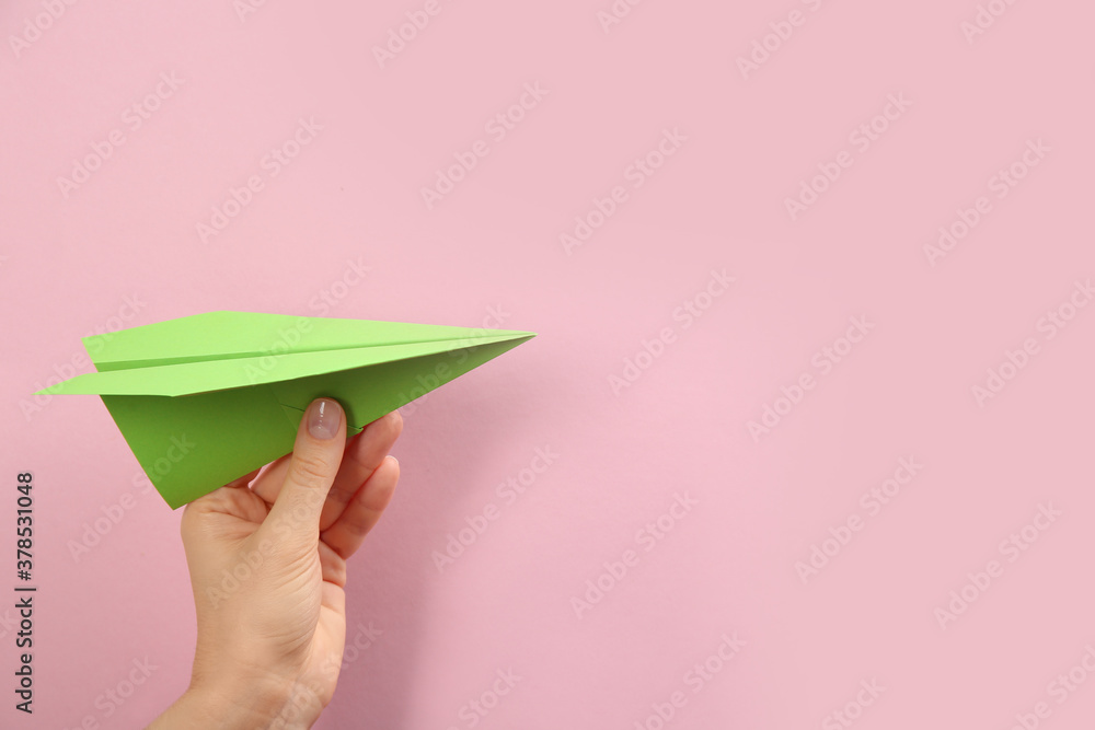 Sticker Woman holding paper plane on pink background, closeup. Space for text