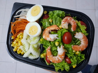 Green vegan salad from green leaves mix and vegetables. eat clean  for heaalthy.Top view on gray stone table.