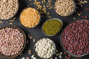 Many different types of haricot beans in studio on black
