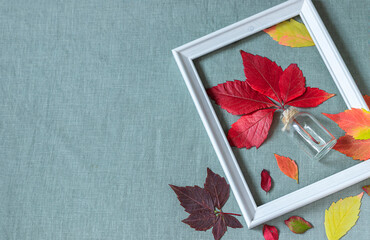 Autumn background from leaves on a background of linen fabric. Autumn still life.