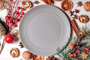  Empty plate in Christmas decoration, top view. Place for text on a plate