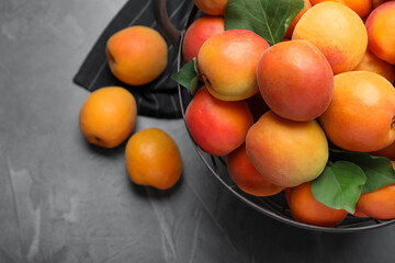 Delicious fresh ripe apricots on dark table, flat lay