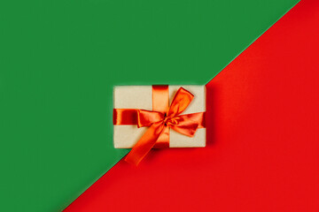 Gift on a green and red color background, holiday gifts concept