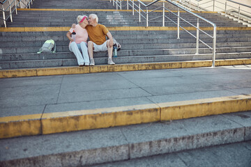 Loving elderly couple sitting on the stairs