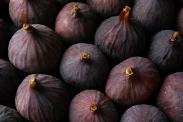 Tasty raw purple figs as background, closeup
