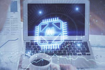 Double exposure of laptop computer and technology theme hologram. Concept of freelance work.