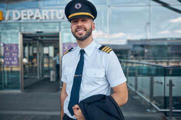 Handsome male pilot standing on the street © Svitlana