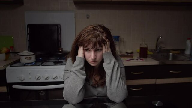 sad tired woman sitting in the kitchen at home, deadlock