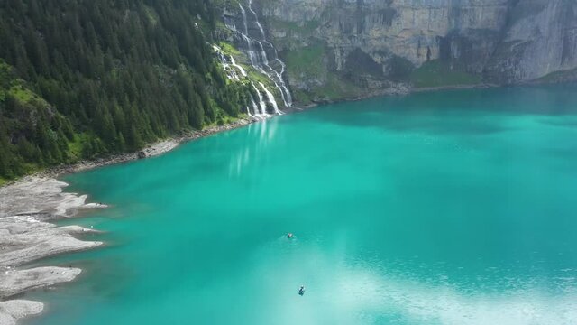 Mountain lake between the giant mountains on a cloudy and moody morning. It is captured in the Swiss Alps at Kandersteg with the DJI Mavic Pro 2.