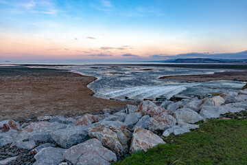 The setting sun paints a magenta light over Dunster Beach