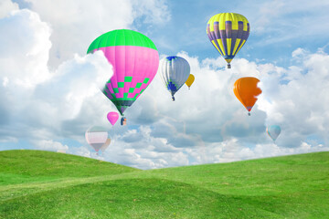 Obraz premium Fantastic dreams. Hot air balloons in sky with fluffy clouds over green meadow