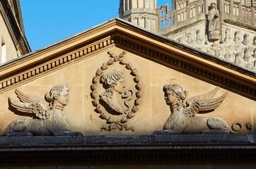 Fototapeta premium Architectural detail of carving of goddess with snake in Royal Bath Spa, UK