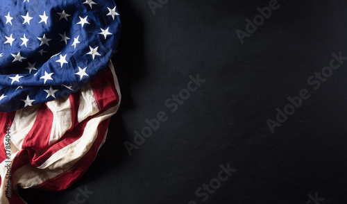 Happy Veterans Day concept. American flags against a blackboard background. November 11.