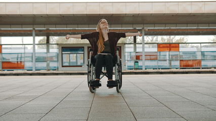 Happy young independent disabled woman on the train station. High quality photo