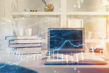 Stock market chart hologram drawn on personal computer background. Double exposure. Concept of investment.