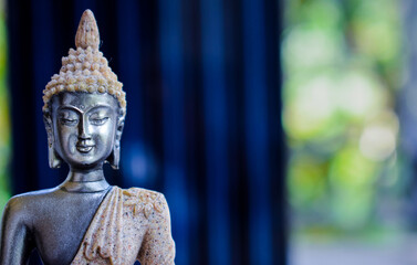 Statue of Buddha sitting in meditation With  space on the right hand side © INDRAJIT