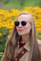 Portrait of a beautiful young woman with sunglasses in autumn