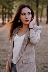 Long-haired brunette in a white t-shirt and jacket