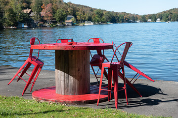 Fototapeta na wymiar Chairs leaning on table signify the end of the Summer Season at a resort on Oquaga Lake in Upstate NY