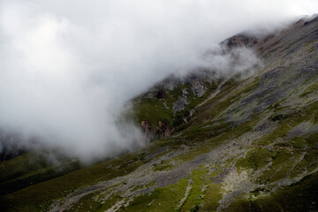 Mountain range in the clouds. Mountain pass in the fog. Caucasus Mountains, Russia.