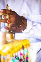 close up of the hand of a  balinese priest giving a blessing during a ceremony