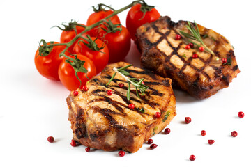 Grilled pork chops with vegetables-cherry tomatoes, peppers, parsley on a wooden Board. Isolate.