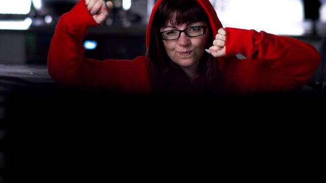 happy woman at home in the evening watching tv and dancing, have fun