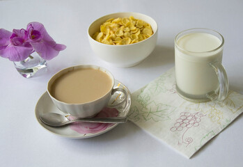 Breakfast with black coffee with hot milk and sweet cereals