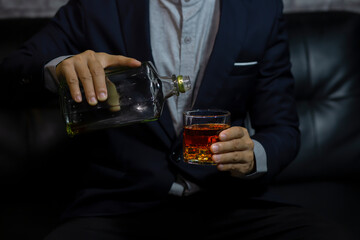 Closeup businessmen holding a glass of whiskey