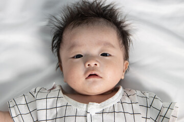 Portraiture image of Three month old Asian Cute little baby boy lsolated on white background